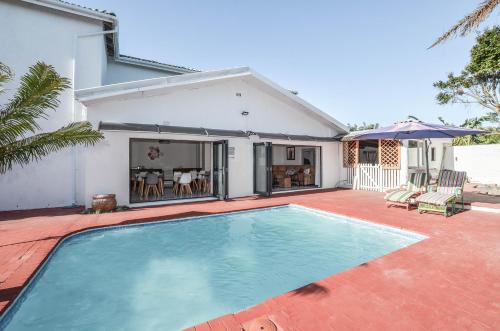 a swimming pool in front of a house at Casa Milner Guest House in Cape Town