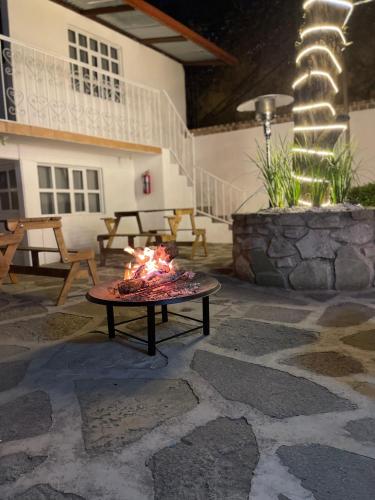 a fire pit in the middle of a patio at Casa Valentino Trattoria & Alojamiento in Mineral del Monte