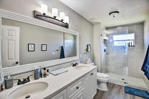 a bathroom with a sink and a toilet and a mirror at New Smyrna Beach Townhome, Walk to Bay Access! in New Smyrna Beach