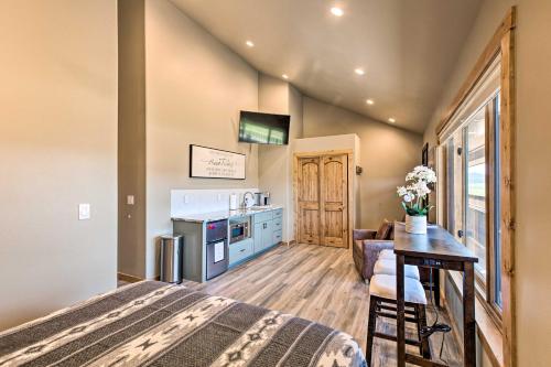 a bedroom with a large bed and a kitchen at Dreamy Angel Fire Studio Less Than 2 Mi to Ski Resort! in Angel Fire