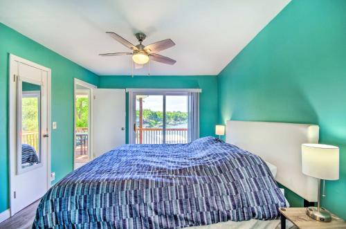 a bedroom with a bed and a ceiling fan at Sunrise Beach Home with Boat Dock on the Ozarks in Sunrise Beach