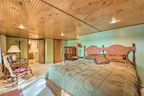 a bedroom with a large bed with a wooden ceiling at Le Roy Lakefront Retreat with Dock and Kayaks! in Le Roy