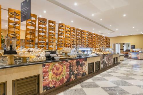 a restaurant with a buffet of food on display at Iberostar Selection Praia do Forte - All Inclusive in Praia do Forte