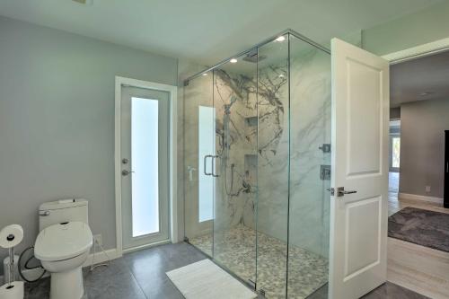 a bathroom with a glass shower with a toilet at Jupiter Home with Private Pool and Putting Green! in Jupiter