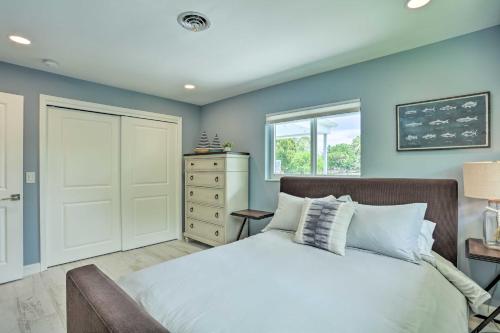 a bedroom with blue walls and a bed and a window at Jupiter Home with Private Pool and Putting Green! in Jupiter