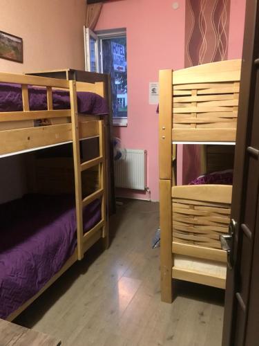 a room with two bunk beds and a window at RiverSide Hostel Borjomi in Borjomi