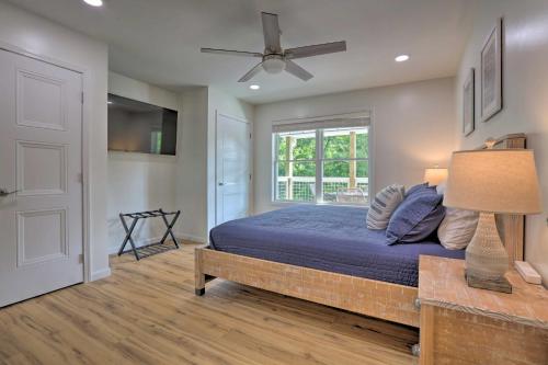 a bedroom with a bed and a ceiling fan at Rough River Lake House with Dual Primary Suites! in Fentress McMahan