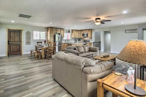 a living room with a couch and a table at Game Room and Wooded Views Pinetop Cabin! in Pinetop-Lakeside