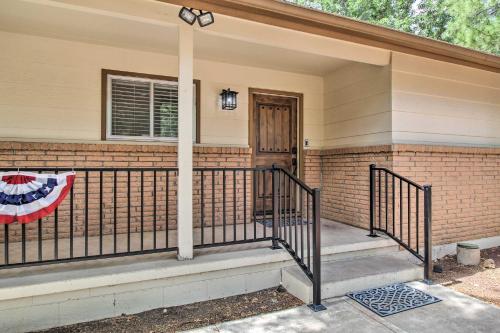 a front porch of a home with a flag on it at Game Room and Wooded Views Pinetop Cabin! in Pinetop-Lakeside