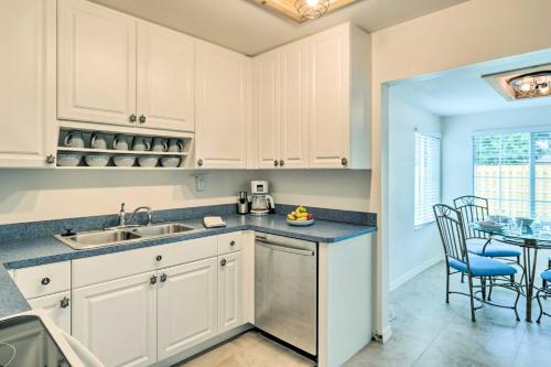 a kitchen with white cabinets and a table with chairs at Punta Gorda Retreat Near Historic Downtown! in Punta Gorda