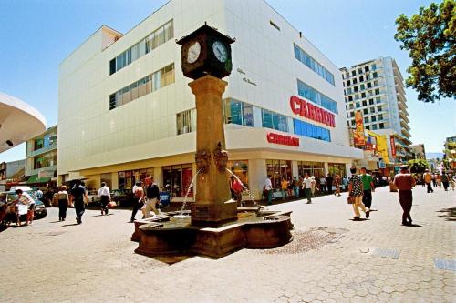 a clock tower in the middle of a street at Hotel Quinta Avenida in San José