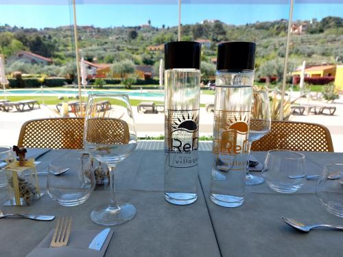a table with wine glasses on top of it at ReBi Village in Imperia
