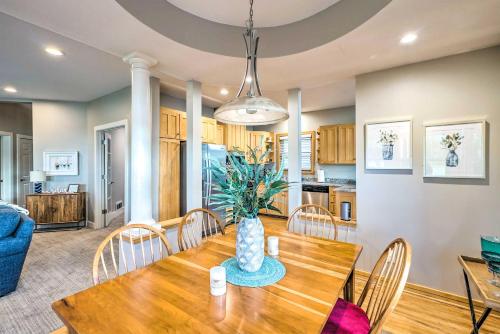 a dining room and kitchen with a wooden table and chairs at Waterfront Mound Retreat with Dock and Lake Access! in Mound