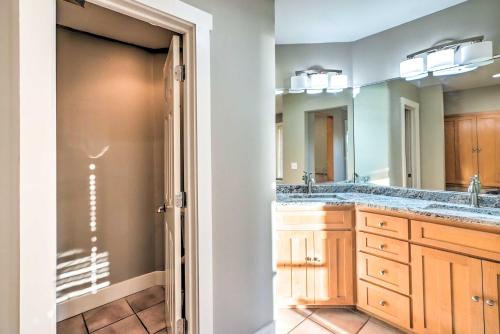 a bathroom with a double sink and a mirror at Waterfront Mound Retreat with Boat Dock Access! in Mound