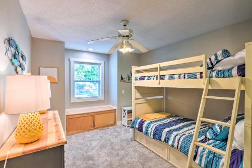 a bedroom with two bunk beds and a desk at Waterfront Mound Retreat with Dock and Lake Access! in Mound