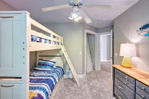 a bedroom with a bunk bed and a ceiling fan at Waterfront Mound Retreat with Dock and Lake Access! in Mound