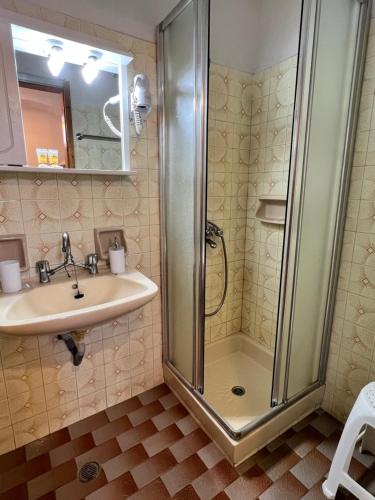 a bathroom with a shower and a sink at ERIDA Accommodation in Lákka