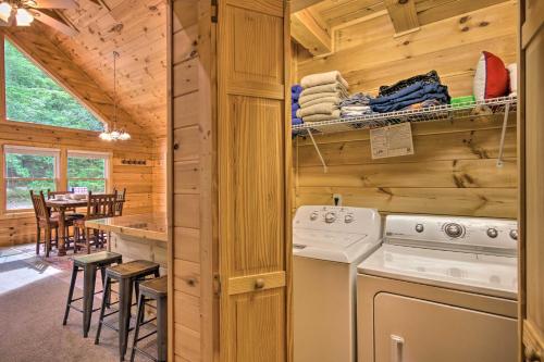 una cucina e una sala da pranzo in una baita di tronchi di Moonshine Manor Cabin with Fire Pit and Hot Tub! a Lake Lure