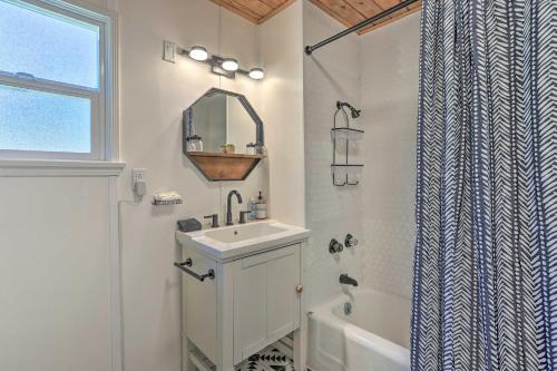 a white bathroom with a sink and a mirror at 2 Mi to Big Bear Lake Cabin with Game Room in Big Bear City