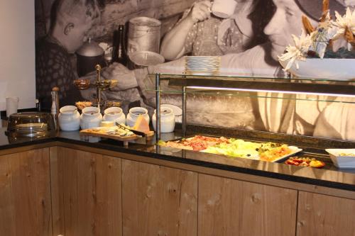 a buffet line with pizzas and other food items at Hotel Piz Buin in Ischgl