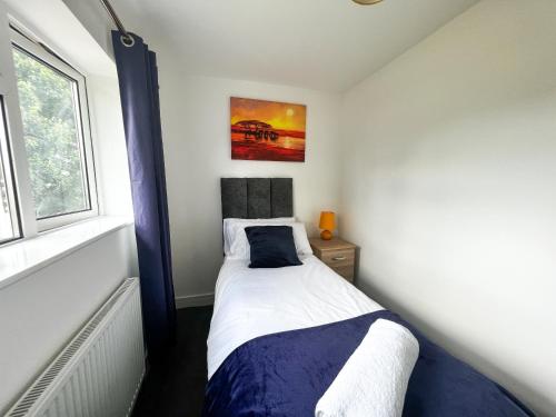 a small bedroom with a bed and a window at Starview Apartment - Hawthorne in Colchester