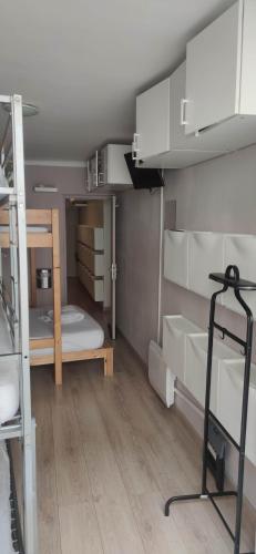 a room with white bunk beds and a ladder at logement entier a 15 mn d'Avignon, 10mn d'Orange deux chambres in Roquemaure