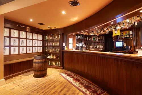 a bar with a barrel in the middle of it at Royal Golf Hotel in Dornoch