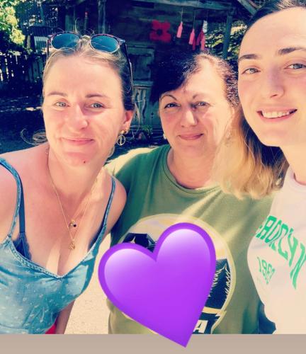 a group of three women posing with a purple heart at Butichi Guest House in Chiatʼura