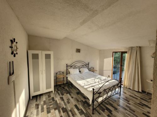 a bedroom with a bed and a large window at Vila Kalypso in Schitul