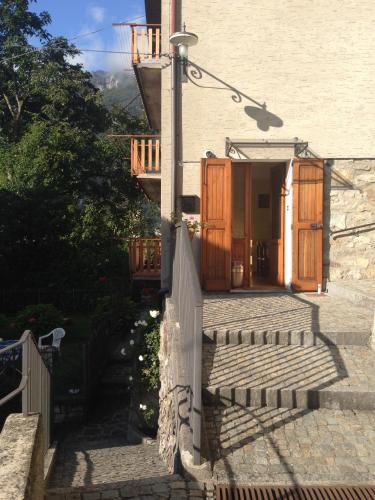 a building with a staircase and a street light at Bed & Breakfast Casa Marinella in Lenna