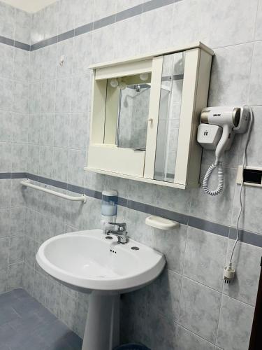 a bathroom with a white sink and a mirror at Villa delle Muse da Imma in Palinuro