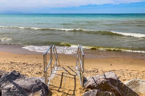 a beach with a chair on the sand and the ocean at Eagles Nest in New Buffalo