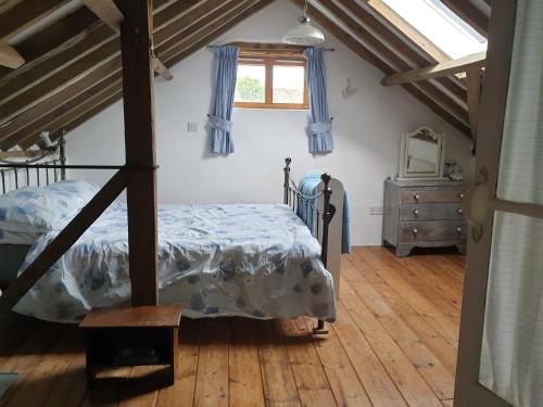 a bedroom with a bed and a window at The Granary in Hardwick