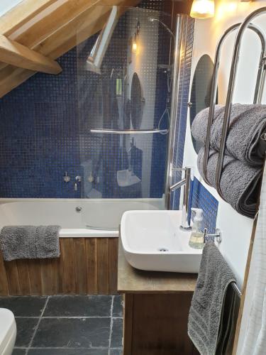 a bathroom with a sink and a bath tub at The Granary in Hardwick