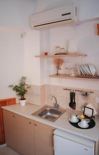 a kitchen with a sink and a counter top at Malia Boutique Studios in Malia