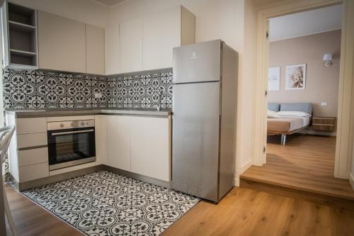 a kitchen with a stainless steel refrigerator in a room at Dimora Donna Dora - Albergo Diffuso in San Martino in Pensilis