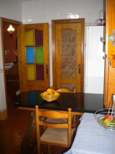 a kitchen with a table with a bowl of fruit on it at Casa Cabo de Gata in Retamar