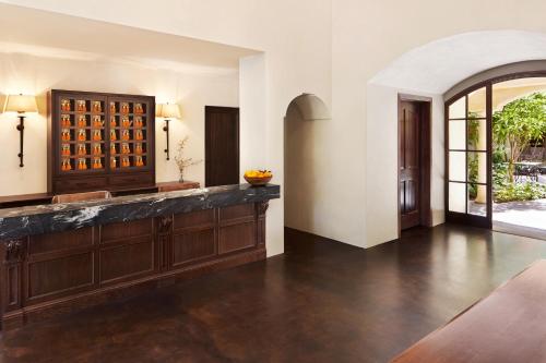a large tasting room with a wine rack and a tasting table at Kenwood Inn & Spa in Kenwood
