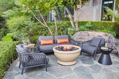 a patio with a couch and chairs and a fire pit at Kenwood Inn & Spa in Kenwood
