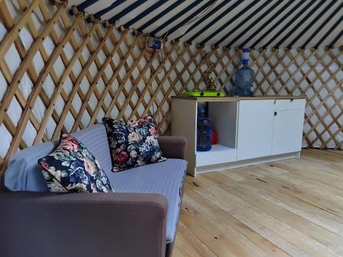 a room with a couch and a cabinet in a yurt at Jurta Ve Hvozdech in Blansko