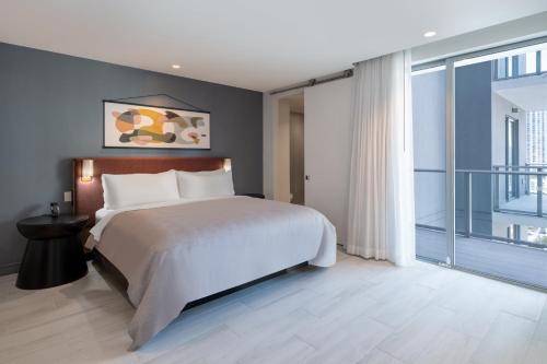 a bedroom with a large bed and a large window at Atwell Suites Miami Brickell by IHG in Miami