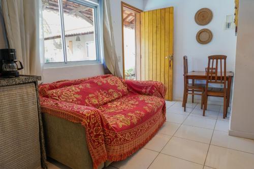 uma sala de estar com um sofá vermelho e uma janela em Vila Ebert em Niterói