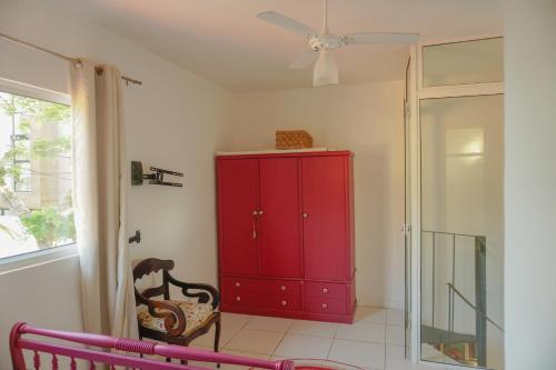 a red cabinet in a room with a window at Vila Ebert in Niterói