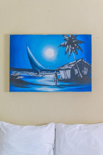 a painting of a beach with a palm tree at Hotel Preá in Prea