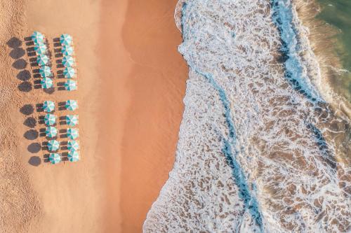 an overhead view of a beach with a group of umbrellas at Iberostar Waves Bahia - All Inclusive in Praia do Forte
