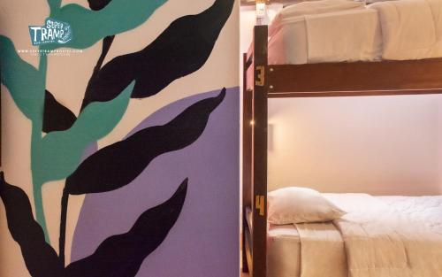 a bedroom with a bunk bed with a mural of birds at Supertramp Hostel Machupicchu in Machu Picchu