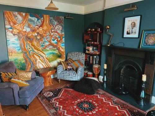 a living room with a couch and a fireplace at Dylan Thomas Sea View in Laugharne