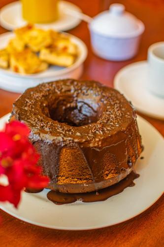 a chocolate cake on a plate on a table at Hotel Preá in Prea