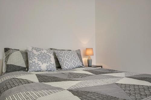 a bedroom with a large bed with pillows at Flat C, Old Street in London