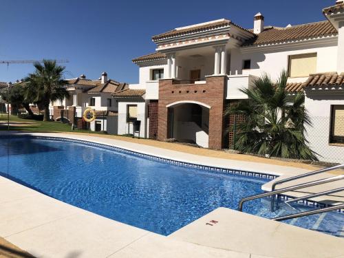 a swimming pool in front of a house at Albatros Golf View 2394 in Casares